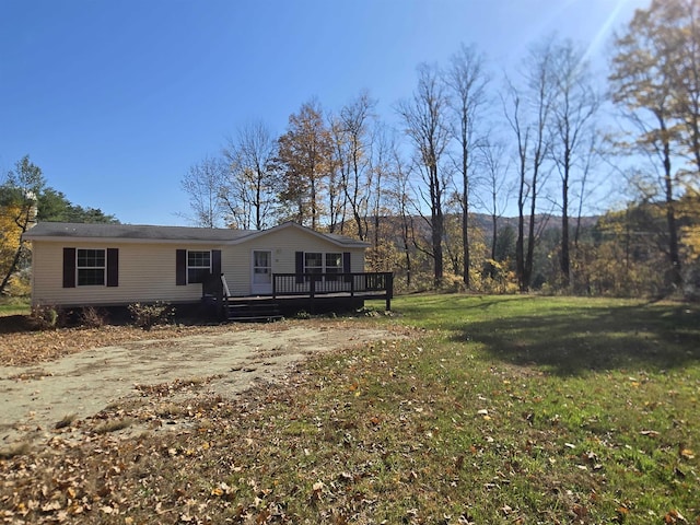 exterior space featuring a front yard and a wooden deck