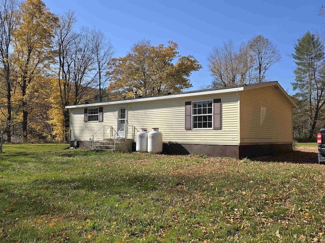 back of property with a lawn