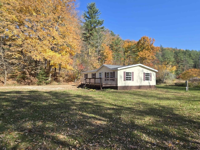 exterior space with a lawn and a wooden deck