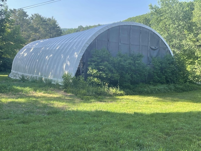 view of outdoor structure featuring a lawn