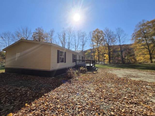 view of property exterior featuring a wooden deck