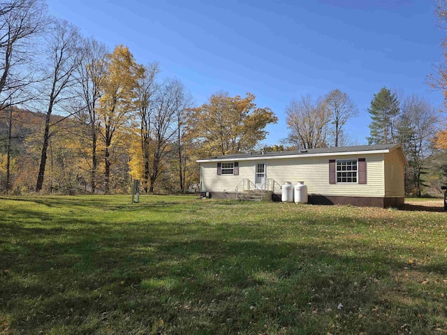 rear view of house with a yard