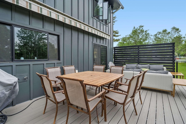 wooden terrace featuring area for grilling and outdoor lounge area