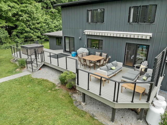 back of house with an outdoor hangout area, a deck, and a lawn