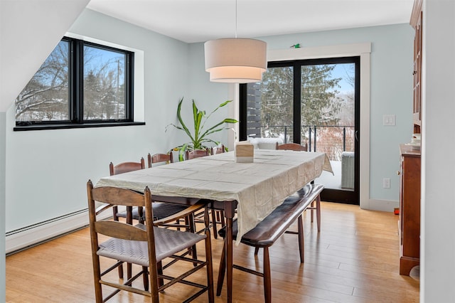 dining room featuring light hardwood / wood-style flooring and a baseboard heating unit