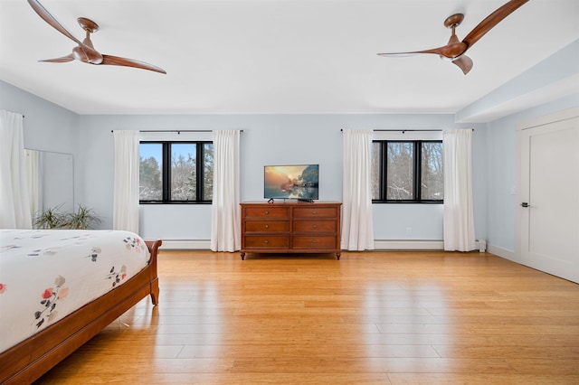 unfurnished bedroom with multiple windows, ceiling fan, and light wood-type flooring