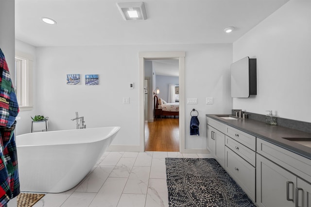 bathroom with vanity and a bathing tub