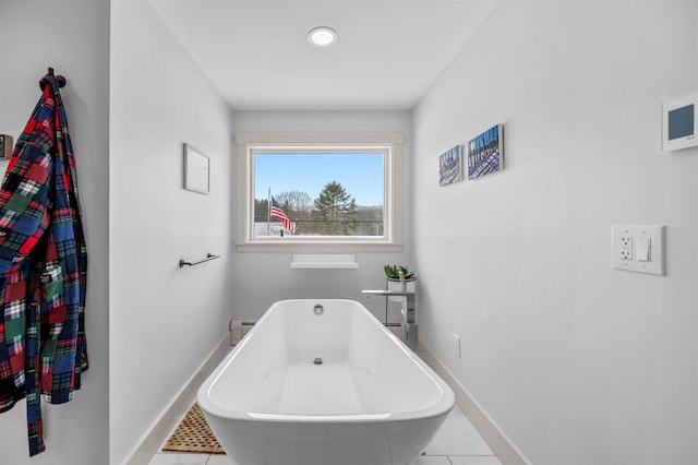 bathroom featuring tile patterned floors and a bathtub