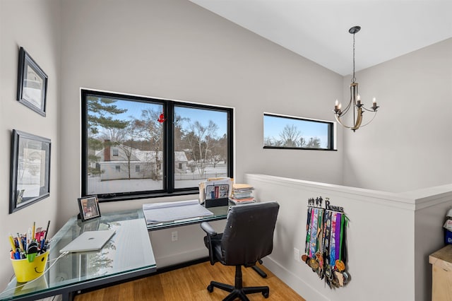 home office with a chandelier and hardwood / wood-style floors