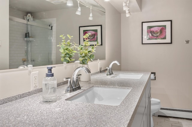 bathroom with vanity, toilet, an enclosed shower, and a baseboard heating unit