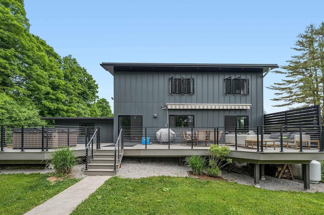 back of house featuring a wooden deck and a yard