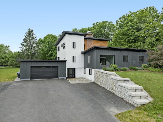 view of front of home featuring a garage and a front lawn