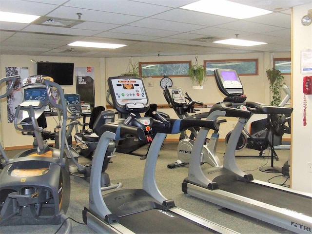 exercise room with a paneled ceiling