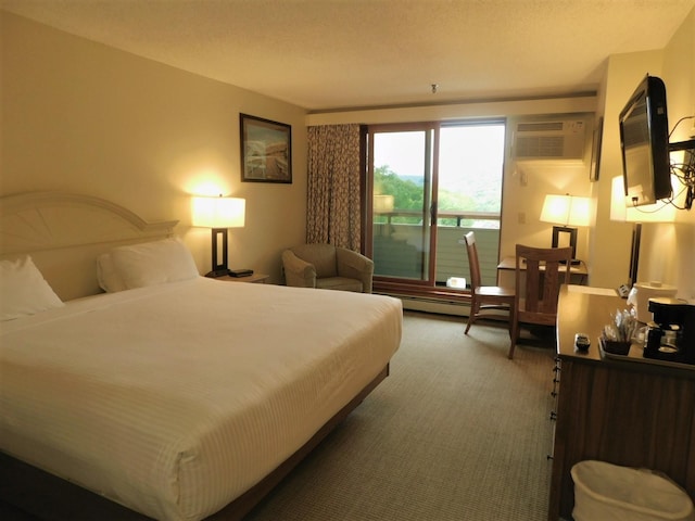 bedroom featuring carpet flooring and a wall unit AC