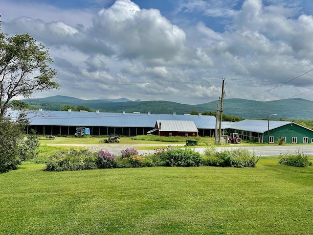 view of home's community featuring a yard and a mountain view