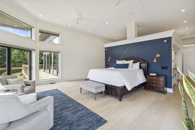 bedroom with access to outside and light hardwood / wood-style flooring