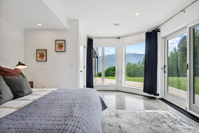 bedroom featuring concrete flooring and access to outside