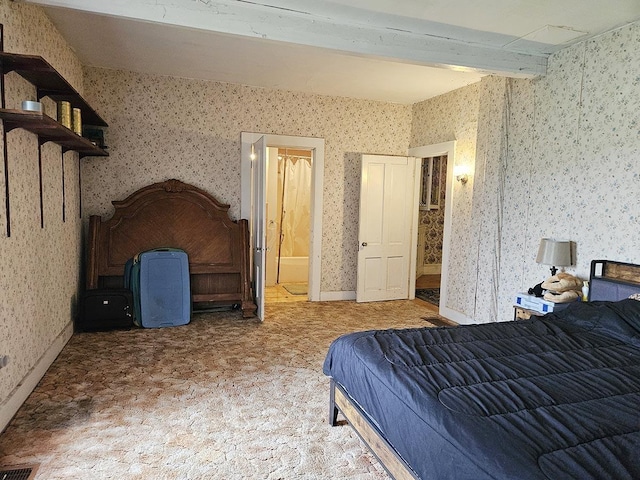 bedroom with ensuite bathroom, visible vents, beam ceiling, and wallpapered walls