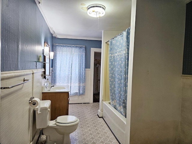 full bathroom featuring toilet, vanity, ornamental molding, wallpapered walls, and shower / bathtub combination with curtain