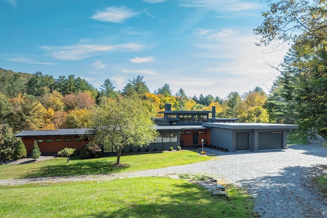 contemporary home with a front yard and a garage