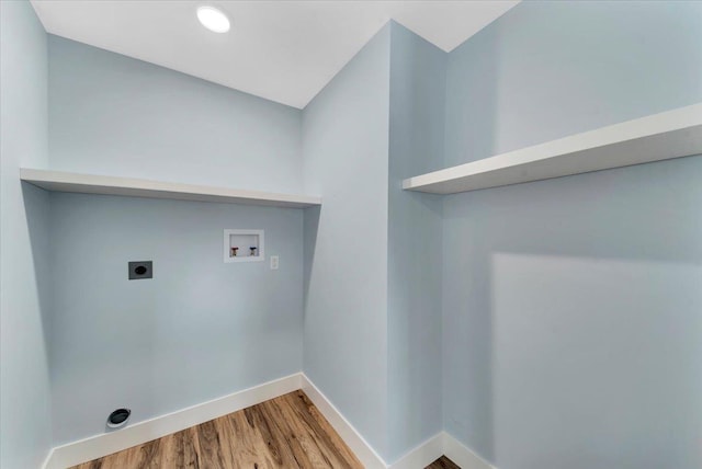 laundry area featuring washer hookup, wood finished floors, baseboards, hookup for an electric dryer, and laundry area