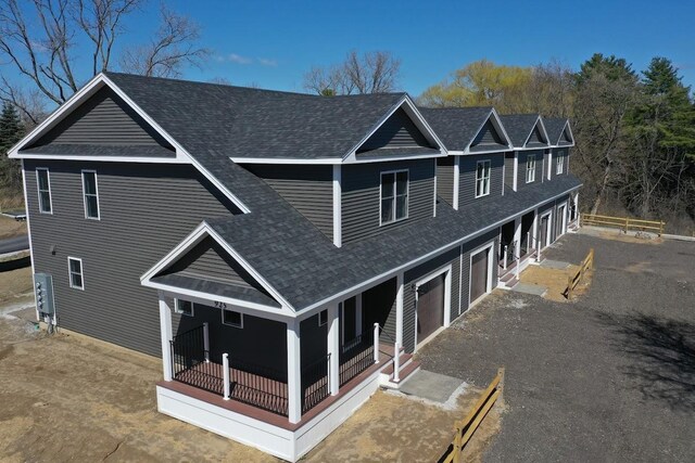 925 Falls Rd Unit 1, Shelburne, VT 05482 - view of front facade featuring a porch, an attached garage, aphalt driveway, and roof with shingles