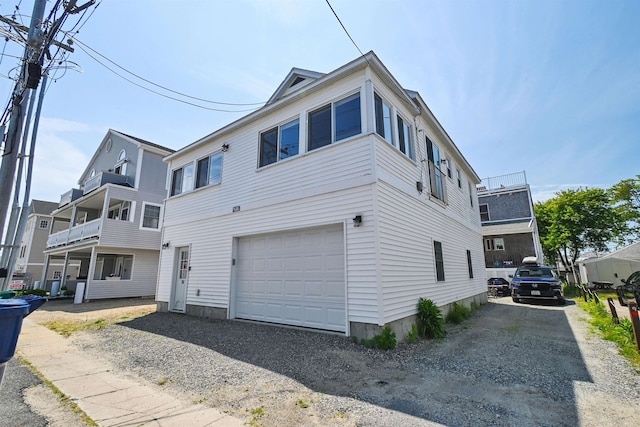 view of front of property featuring a garage and a balcony