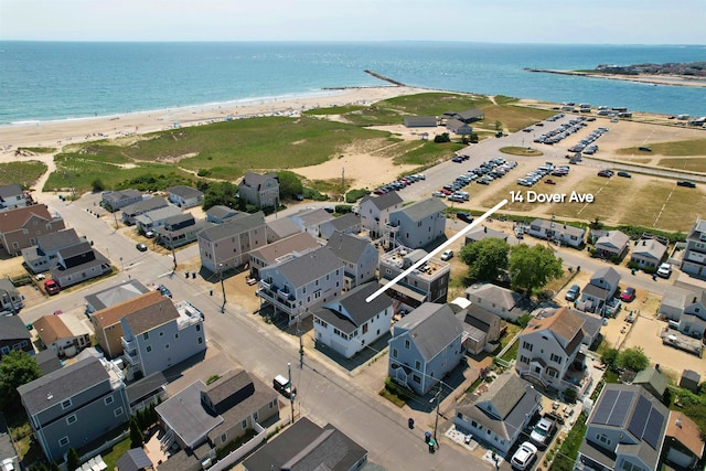 drone / aerial view featuring a beach view and a water view