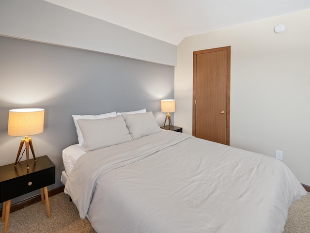 bedroom with lofted ceiling and carpet floors