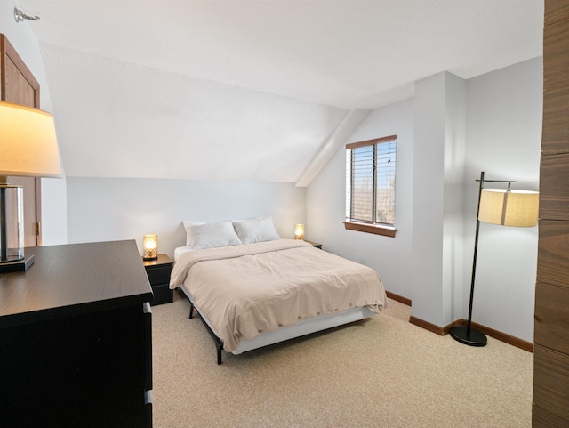 carpeted bedroom featuring lofted ceiling