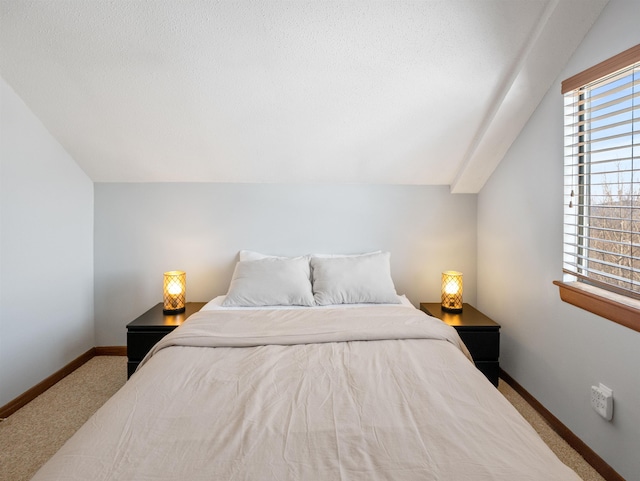 bedroom featuring carpet and lofted ceiling