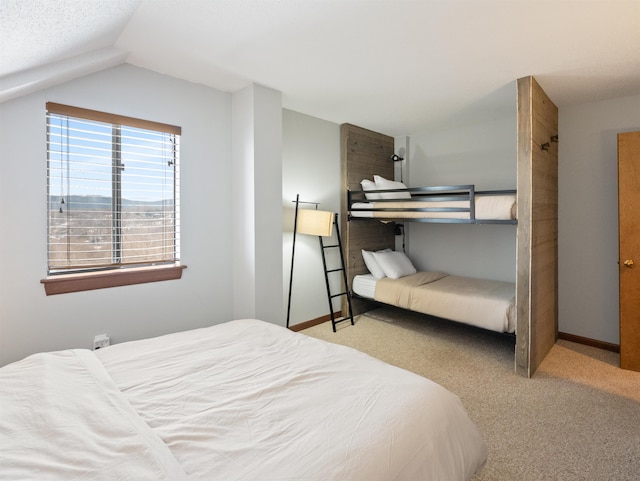 carpeted bedroom with vaulted ceiling