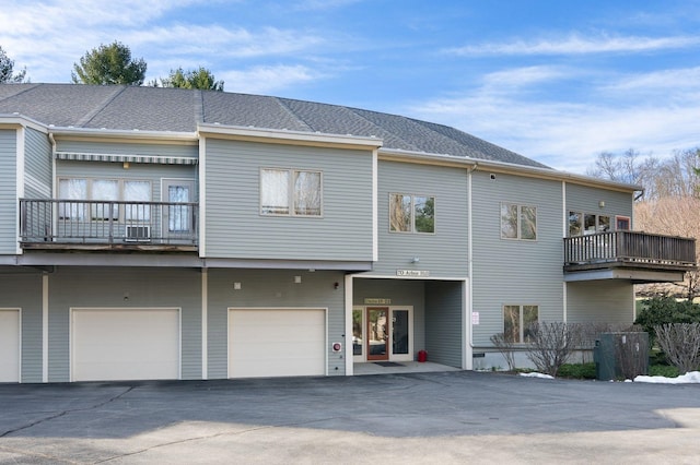 rear view of property featuring a garage