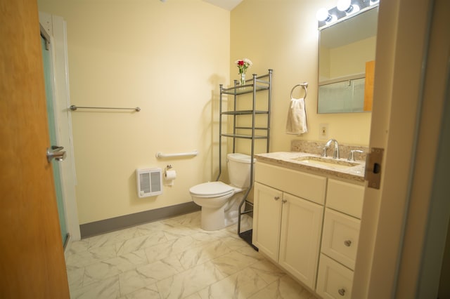 bathroom with heating unit, toilet, and vanity