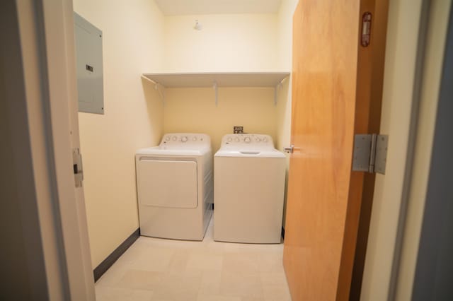 clothes washing area featuring washer and clothes dryer and electric panel