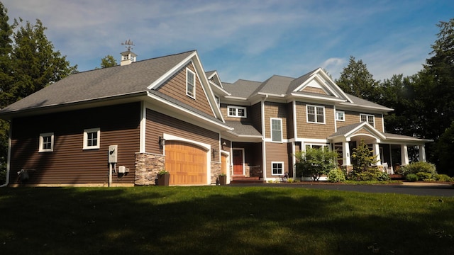 craftsman inspired home with a garage and a front yard