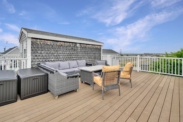 wooden deck with an outdoor living space