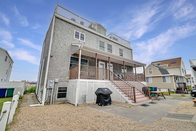 rear view of house featuring a porch