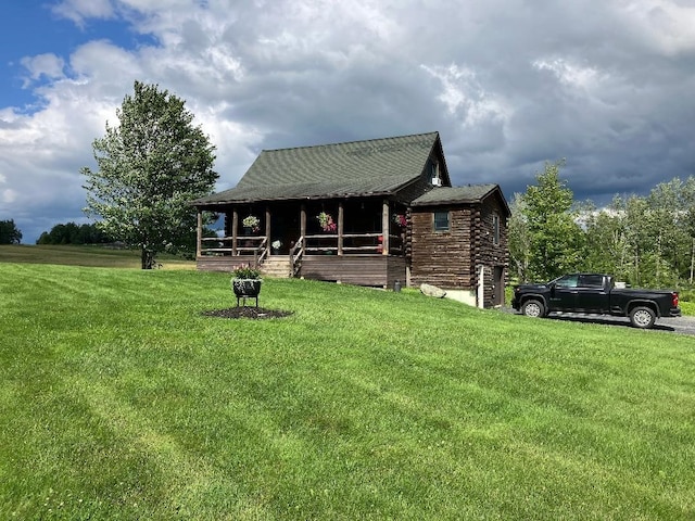 log home featuring a front yard and log siding