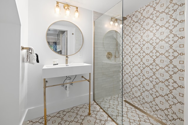 bathroom with sink and a tile shower