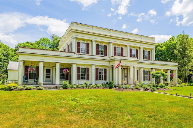 view of front of house with a porch and a front lawn