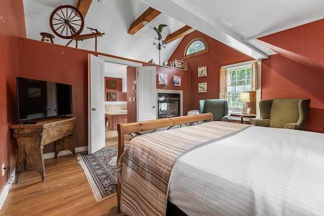 bedroom featuring lofted ceiling with beams, light hardwood / wood-style floors, and a multi sided fireplace