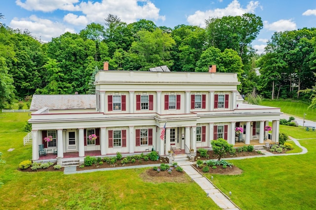 view of front of house featuring a front yard and covered porch