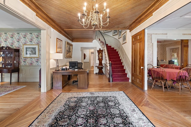 foyer entrance featuring an inviting chandelier, wood ceiling, ornamental molding, and light parquet flooring