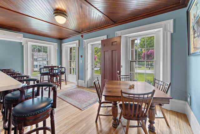 dining room featuring a wealth of natural light, ornamental molding, and light wood-type flooring