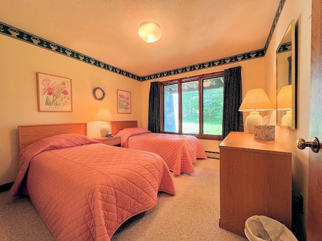 34 Sugar Brook Rd Unit F4, Peru, VT 05152 - bedroom with light colored carpet, a textured ceiling, and a baseboard heating unit