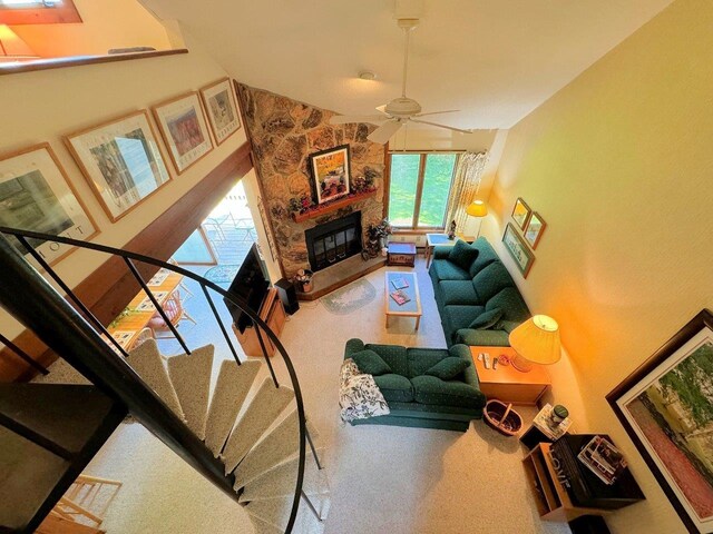 34 Sugar Brook Rd Unit F4, Peru, VT 05152 - carpeted living area with high vaulted ceiling, a stone fireplace, and a ceiling fan
