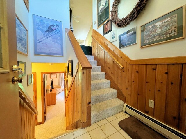 34 Sugar Brook Rd Unit F4, Peru, VT 05152 - stairs with baseboard heating, tile patterned flooring, wainscoting, and carpet