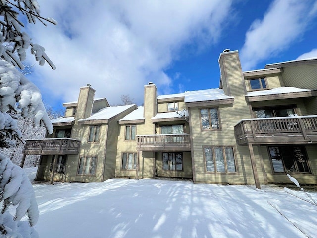 34 Sugar Brook Rd Unit F4, Peru, VT 05152 - snow covered back of property with a balcony and a chimney