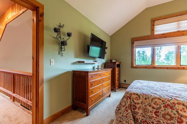 bedroom featuring light colored carpet and vaulted ceiling